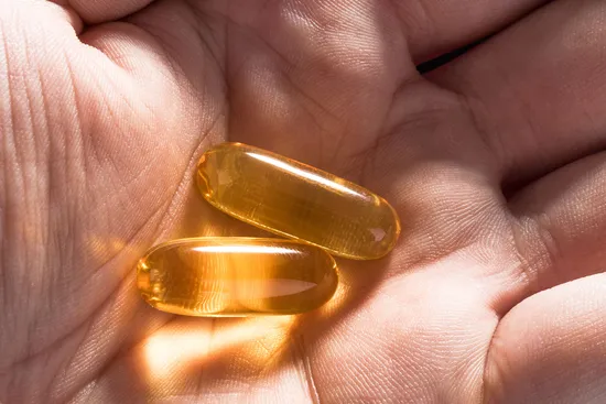 photo of vitamin d pills in hand